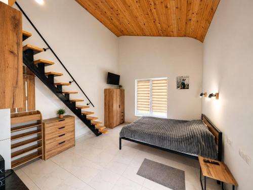 a bedroom with a bed and a staircase at Апарт Стефанія in Skhidnitsa