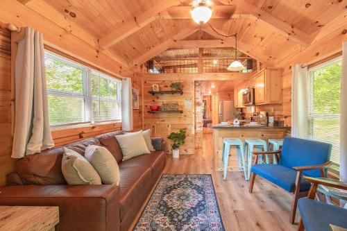 a living room with a couch and a kitchen at Ryon Tiny Home Cabin City-side Rustic Retreat in Chattanooga