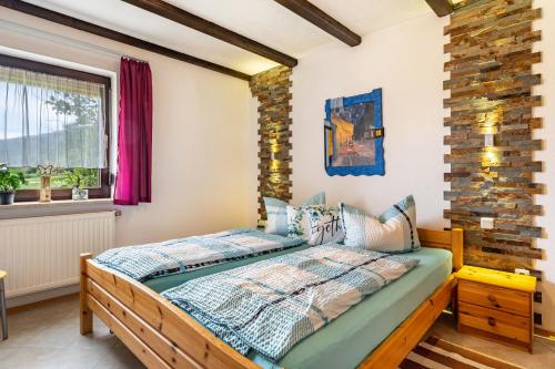a bedroom with a bed and a window at Ferienwohnung Spatzennest in Arrach