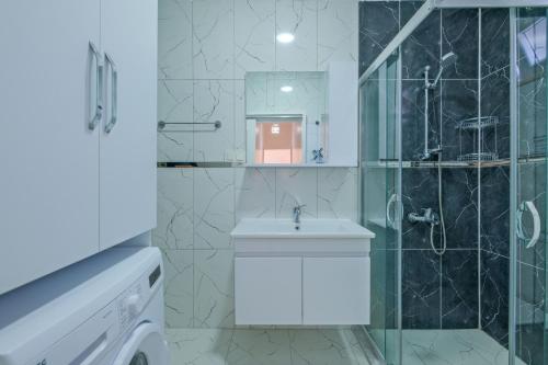 a bathroom with a shower and a toilet and a sink at Villa Ata Park Ortaca in Ortaca