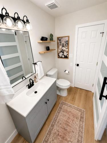 a bathroom with a white sink and a toilet at Moovalya Keys Vacation Home in Parker