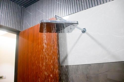 a stream of water coming out of a shower at Hotel Orbit in Parbhani