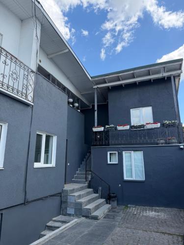 a blue building with stairs on the side of it at AURa in Zhytomyr