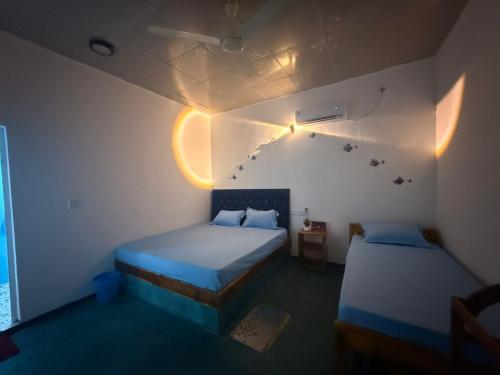 a room with two beds in a room at Afaa Beach Guest House in Arugam Bay