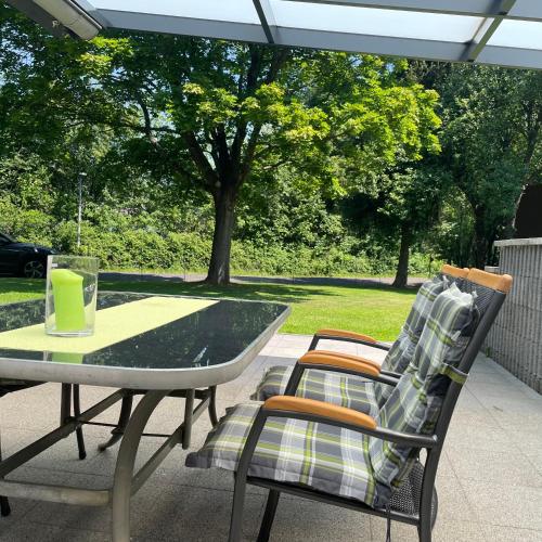 a table and two chairs on a patio at All inclusive Ferienhaus JULYN , Seepark in Kirchheim