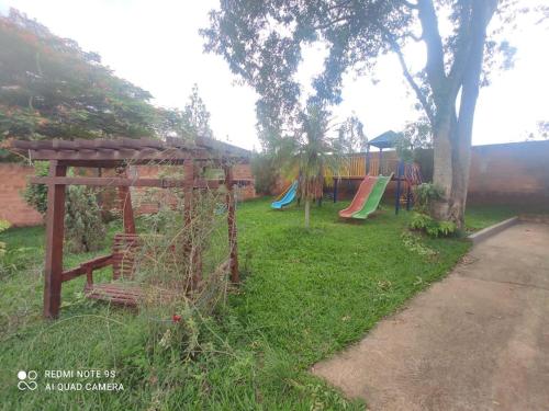 a park with a playground with a swing set at chacara Recanto do ssosego in Olímpia