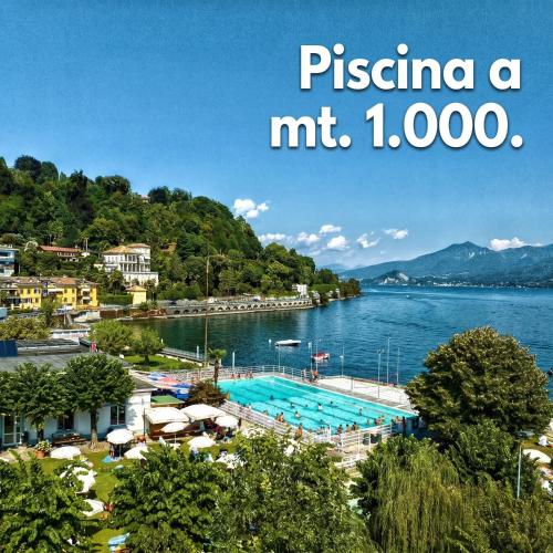 a resort with a large swimming pool in the water at Casa Quadrifoglio - Spalavera in Intra