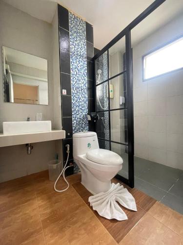 a bathroom with a toilet and a sink at The S Design Hotel in Buriram