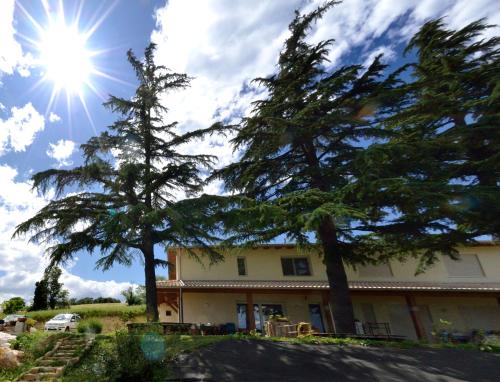 a house with trees and the sun in the sky at B&B Al Tardino in Sogliano al Rubicone