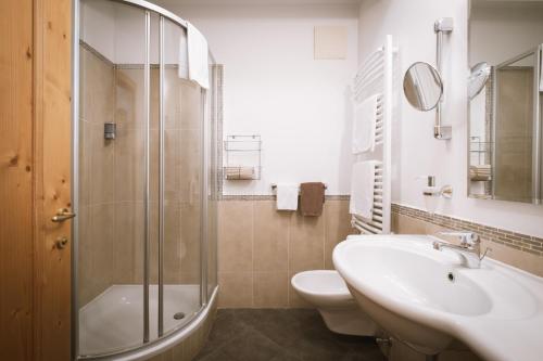 a bathroom with a sink and a shower and a toilet at Hotel Innerhofer in Gais