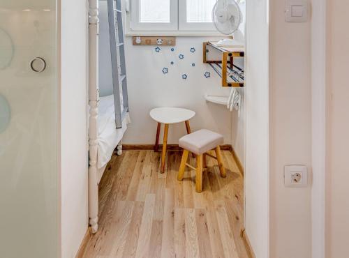 a small room with a stool and a table at Apartment Matoš in Omiš