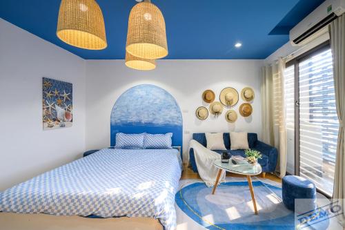 a bedroom with a bed and a table at Little House Đông Tác in Hanoi