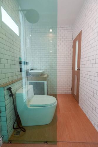 a bathroom with a toilet and a sink at After Beach House Phla Resort in U-Tapao