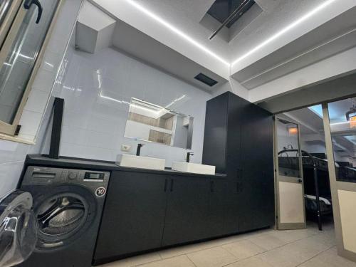 a washer and dryer in a room at Englishman Hostel Shkoder Backpackers Instant Sleep in Shkodër