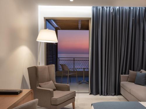 a living room with a view of the ocean at Nana Golden Beach All Inclusive Resort & Spa in Hersonissos
