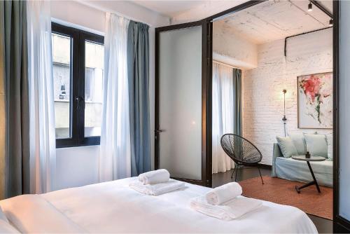 a bedroom with a bed with two towels on it at Sarri 2 by Stay Unique in Athens