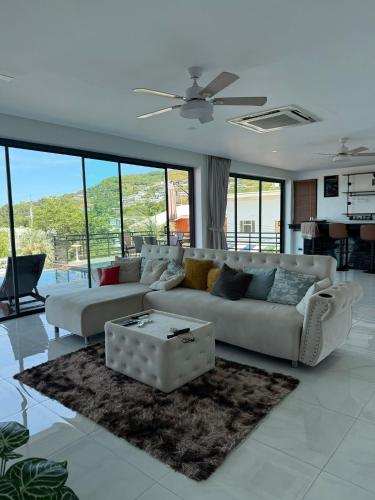 a living room with a couch and a table at Villa Fiesta, 5bd, palace in Mae Nam