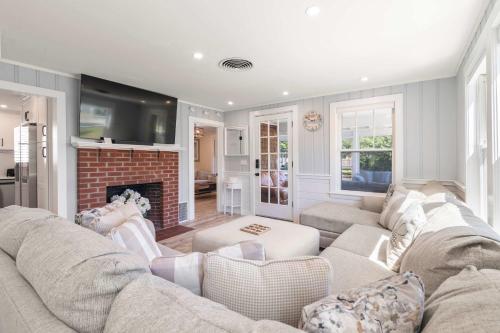 a living room with a couch and a fireplace at Steps to the Beach Cozy Central AC in Yarmouth