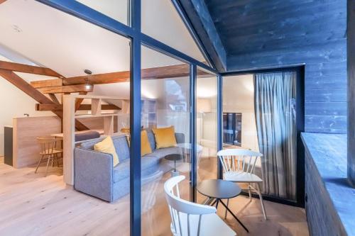 a room with a bed and a table and chairs at Münsterhus Josefs Alpine Lodge in Schruns