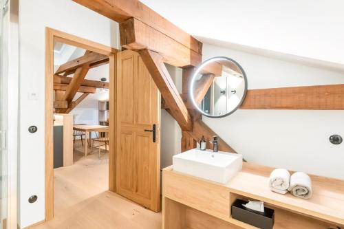a bathroom with a sink and a mirror at Münsterhus Josefs Alpine Lodge in Schruns