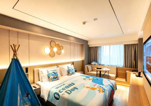 a hotel room with a bed and a couch at Orange Hotel Beijing Yansha Landmark River in Beijing