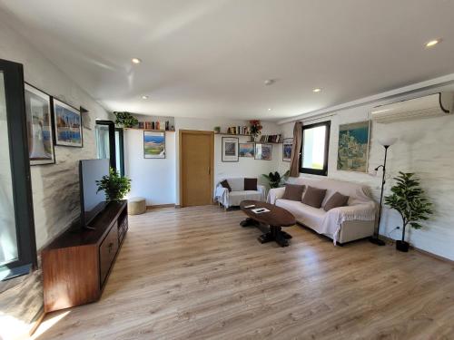 a living room with a couch and a flat screen tv at Jengina, muy centrico in Cadaqués