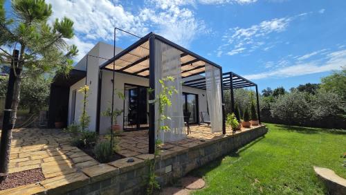 a small house with a glass facade at House B in Dekani