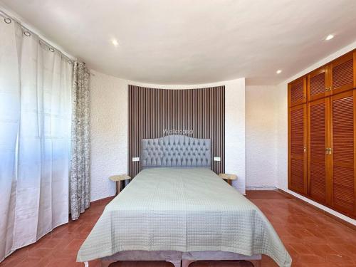 a bedroom with a bed and a large window at Villa Peñón View in Calpe