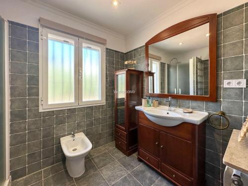 a bathroom with a sink and a toilet and a mirror at Villa Peñón View in Calpe