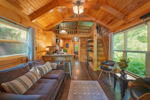 a living room with a couch in a cabin at Thomas Cabin Forest Tiny Cabin With Hot Tub in Chattanooga