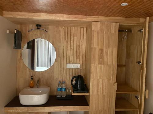 a bathroom with a sink and a mirror at Wanderlust Beach Villa in Agatti