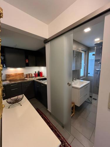 a kitchen with black cabinets and a white counter top at Ferienhaus Ahrenshoop in Ahrenshoop