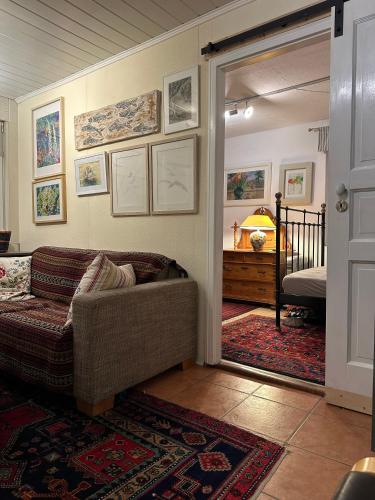 a living room with a couch and a bedroom at Ferienhaus Ahrenshoop in Ahrenshoop