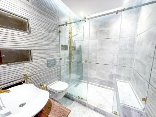 a bathroom with a shower and a toilet and a sink at Petit-villa avec piscine in Marrakesh