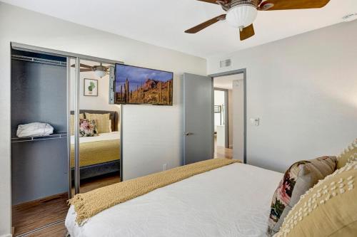 a bedroom with a bed and a ceiling fan at Nova Gypsy Vanner by PaseoHomesAZ with Pool & Pool in Phoenix