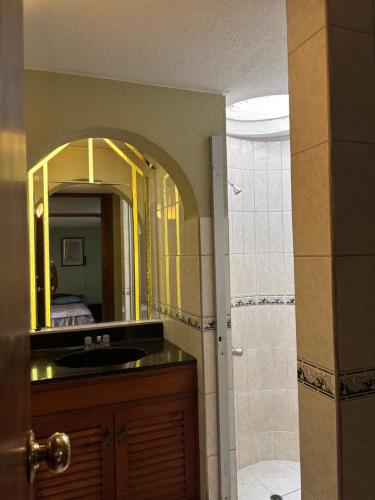 a bathroom with a sink and a mirror at Casa Junto al Rio in Arequipa