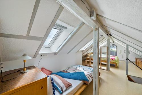 a bedroom with a bed and a desk with a lamp at Ferienwohnung Panorama in Freiamt