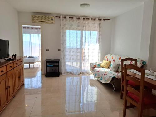 un soggiorno con divano e TV di Apartamento Playaestrella a Vícar