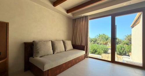 a bed in a room with a large window at Hotel Club Sunway Punta Prima in Es Pujols