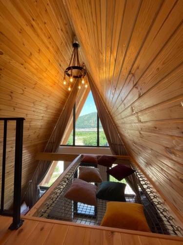 a room with a large window in a wooden cabin at A Frame 2 Transalpina in Sebeş