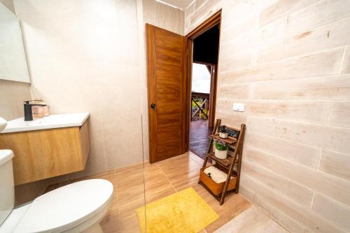 a bathroom with a toilet and a sink at Villa Campestre by Otium in Higuey
