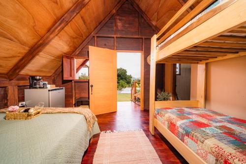 a bedroom with two beds and an open door at Villa Campestre by Otium in Higuey