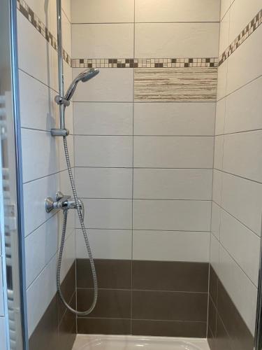 a shower with a hose in a bathroom at Chez Virginie in Rhodes