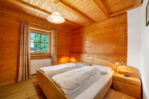 a bedroom with two beds in a wooden cabin at Innerdurachhof in Santa Valpurga