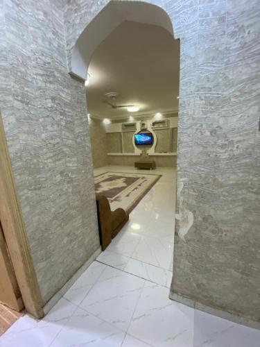 a hallway leading to a living room with a tv at شقة عوقد in Okkad