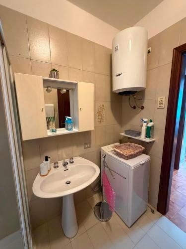 a small bathroom with a sink and a toilet at Cottage di Lola in Fonteno