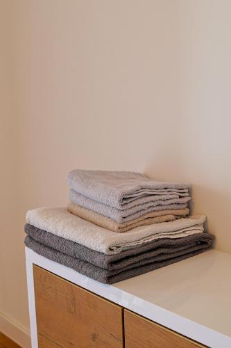 a stack of towels sitting on top of a shelf at Tuzla Tower in Ši Selo