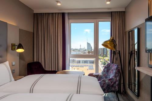 a hotel room with a bed and a large window at Premier Inn Bremerhaven in Bremerhaven