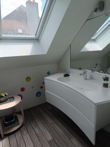 a bathroom with a sink and a window at Petite pom in Azay-le-Rideau