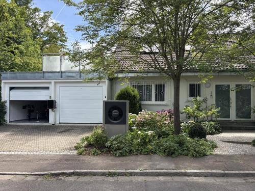 a house with a speaker in front of a garage at Secret Garden in Müllheim